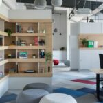 Designing a Workspace That Fuels Slow, Intentional Creativity White wooden shelf with books and red ball